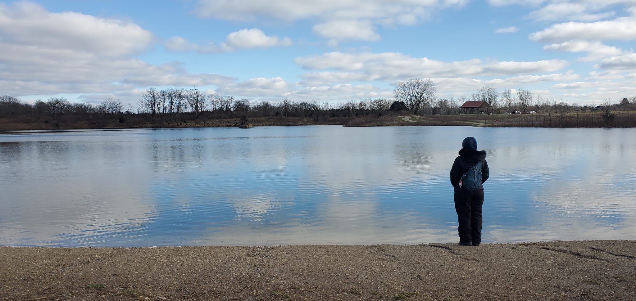 Woman standing in front of pond